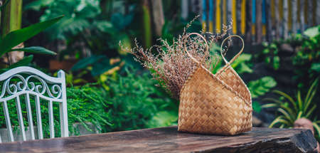 BANNER Cozy garden open air tropical style terrace hard wood table outdoor furniture. Warm mood summer nature day. Modern beauty decor interior atmosphere relax recreation dining areaの写真素材