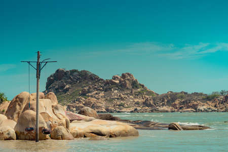 Panoramic view copy space nature landscape background. Calm sea ocean bay sun day summer. Yellow beige gold sand stone rocks beach island. Blue clear sky. Travel play fun paradise concept designの写真素材