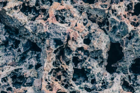 Macro close up rock crack stone solid foamy form raw porous lava volcanic frozen creates pumice ancient lunar style. Light black gray craters lunar slate details texture grain. Abstract backgroundの写真素材