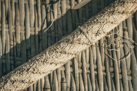 Old woven bamboo rug, rough textile wide rope, fragment banner frame border. Diagonal lines, contrast shadow. Copy space for text. Abstract background. Light brown beige grey tones more in stockの写真素材