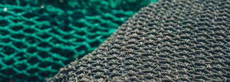 BANNER abstract close-up macro real photo beautiful wallpaper. Fisherman rope net texture fiber surface pattern. Sea blue green light colour. Futuristic subtle waving lines art modern. Dark backgroundの写真素材