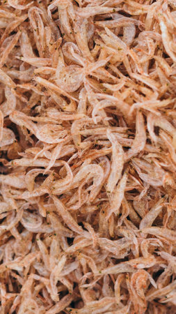 Plenty of dry shrimp background market for sell. Close-up pile texture detail bright light pink pale tone. Vertical format banner wallpaper cuteの写真素材