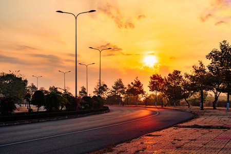 A road with a sunset in the backgroundの写真素材