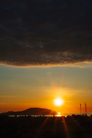 A sunset with a dark cloud in the skyの写真素材