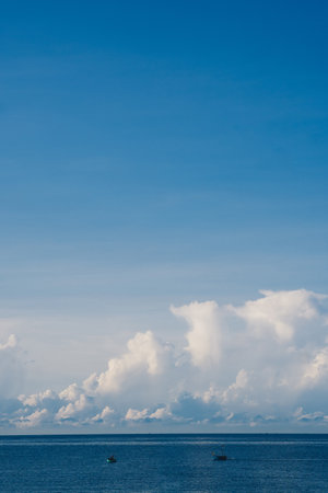 A blue sky with cumulus cumulus fluffy huge summer sun white cloudsの写真素材