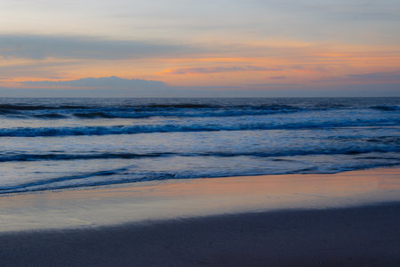 Beach in front of a sunsetの写真素材