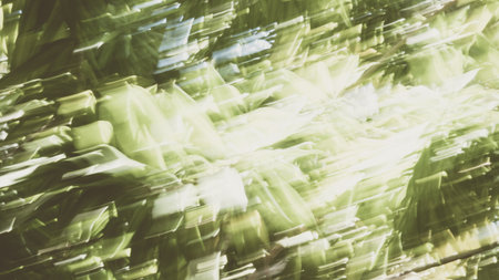 Abstract Nature Blurred dynamic motion lines defocused light bright dark green yellow tropical leaves Wallpaper screensaver design backgroundの写真素材