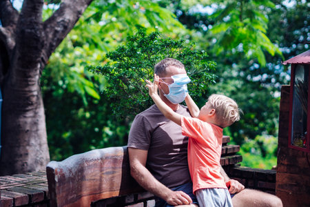Father and little son hugging, making faces, show a tongue, open mouth, funny plays. Happy childhoodの写真素材
