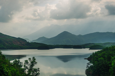 Summer scenery Forested mountains Lake Clouds Sun beams Meditation Inspirationの写真素材