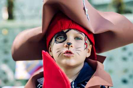 Boy Cat Pirate costume. Halloween party in kindergarten. Aqua makeup painted kids face. Brightの写真素材