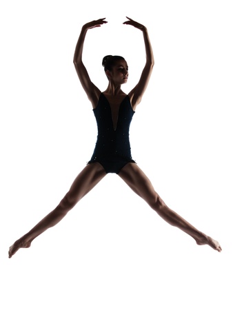 Silhouette of a beautiful female ballet dancer isolated on a white background  Ballerina is barefoot and wearing a dark leotard and short dress の写真素材