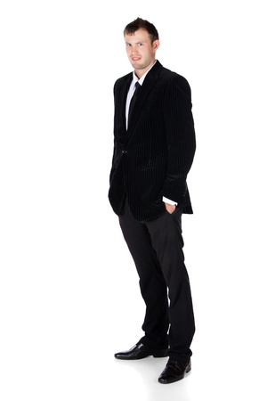 Handsome young successful caucasian businessman wearing a formal black suit, tie and white shirt.の写真素材