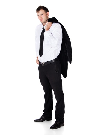 Handsome young successful caucasian businessman wearing a formal black suit, tie and white shirt. He is casually holding his jacket and smiling at the camera.の写真素材