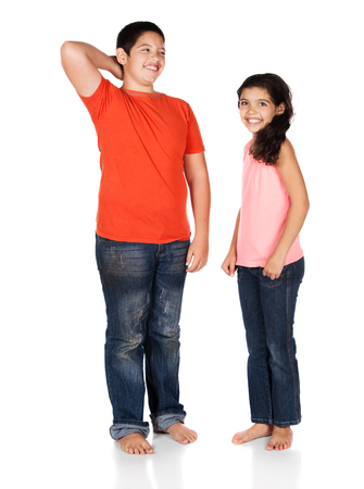 Young caucasian boy wearing a blue t-shirt and jeans and a cute caucasian girl wearing a pink top.の写真素材