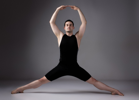 Adult male dancer wearing a black shirt and pants.の写真素材