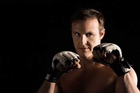 Portrait of a handsome caucasian male mixed martial arts fighter. The guy is wearing white mma...