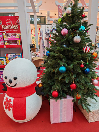 Holiday mall display with Christmas tree, snowman, and Mattel toy shelf promoting festive shopping and gift-givingのeditorial素材