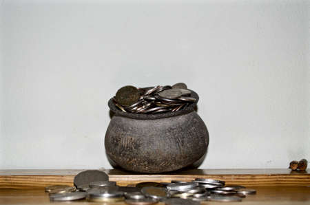 The Coins from around the world in the old black pottery isolated for collecting, business concept , Save money conceptの写真素材