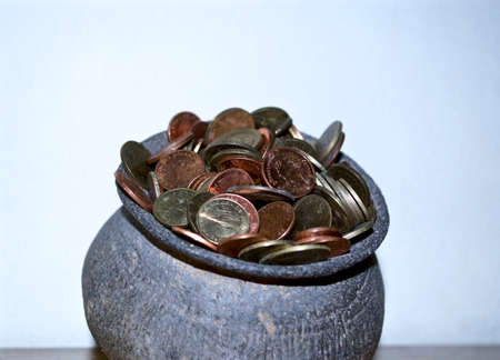 The Coins from around the world in the old black pottery isolated for collecting, business concept , Save money conceptの写真素材