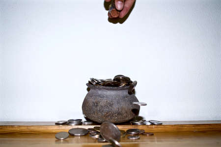 The Coins from around the world in the old black pottery isolated for collecting, business concept , Save money conceptの写真素材