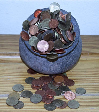 The Coins from around the world in the old black pottery isolated for collecting, business concept , Save money conceptの写真素材