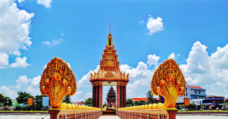 Golden Independence monument, Naga bridge walk way through the monument with beautiful clouds and blue sky background, Ta Keo, Cambodiaの写真素材