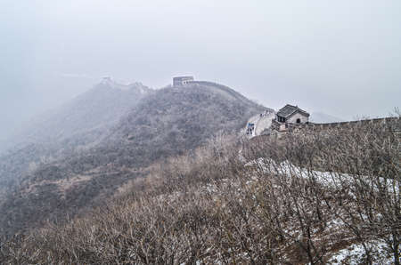 Foggy view in winter weather at The Great Wall "Mutianyu" in Beijing, China.の写真素材