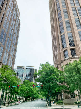 A low angle shot of a street with tall buildings in the backgroundの写真素材