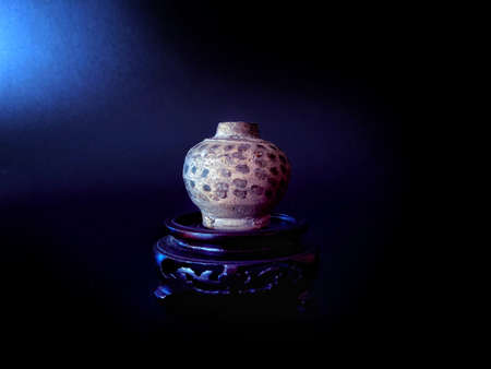 Vintage ceramic vase on a black background. Selective focus.の写真素材