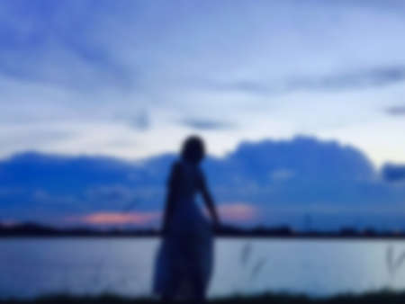 defocus blured of silhouette woman play yoga in morning sky for backgroundの写真素材