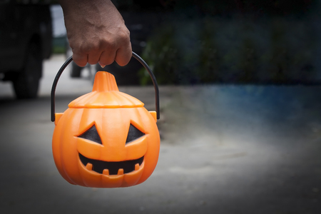 human hand hold pumpkin bucketの写真素材