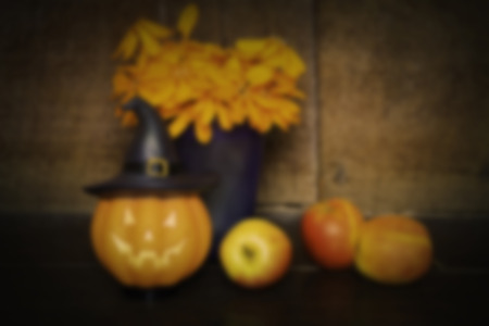 halloween set ,de-focused pumpkin doll and apple on wooden background , black vignetteの写真素材