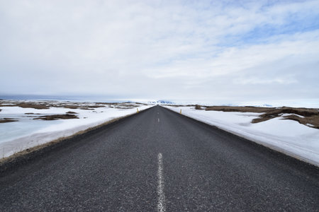 Icelandic road in winter with snow and icelandic landscape