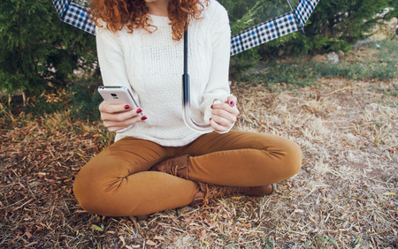Young woman using her mobile phoneの写真素材