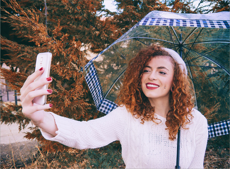 Young happy woman with her mobile phone