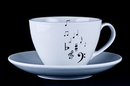 White cup with black musical notes  black backgroundの写真素材