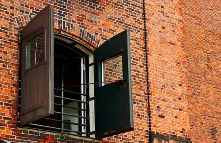 Window with shutters on brick wall