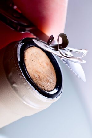 Wine bottle with a barista knife close up