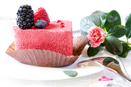 Red cake with berries and pink flower