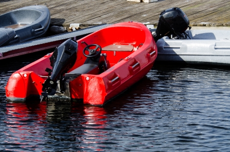 Red boat harbored at pier