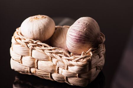 A Basket of Garlic on dark backgroundの写真素材