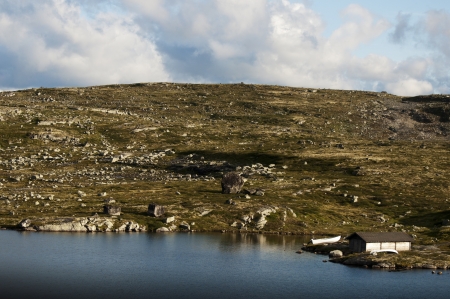 Lone house on lake coast in Norwayの写真素材