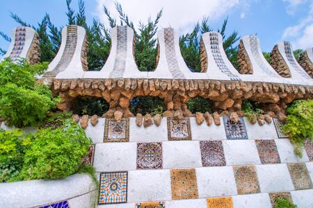 BARCELONA, SPAIN - JULY 13: The mosaic tiles wall in the park Guell, designed by Antonio Gaudi, on July 13., 2012 in Barcelona. Part of the UNESCO World Heritage Site "Works of Antonio Gaudi".のeditorial素材