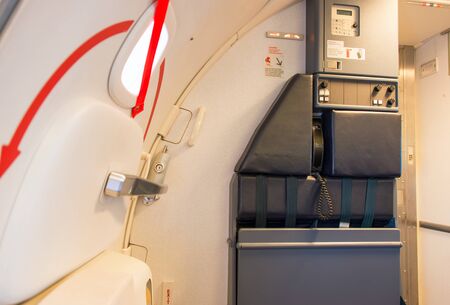 Airplane door and attendant seating placeのeditorial素材