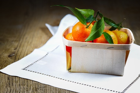 Mandarin Oranges  Clementines  in a shipping box on wooden tableの写真素材