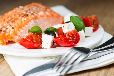 Grilled salmon and greek saladの写真素材