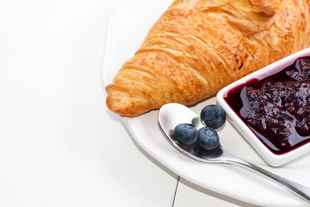 Croissant with jam and blueberry in high key
