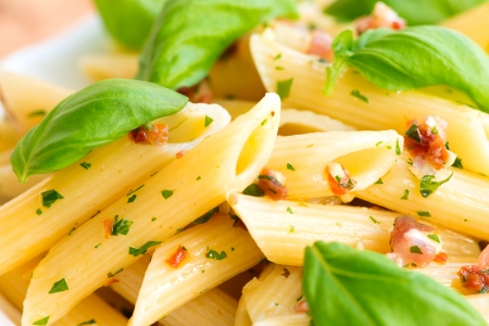 Penne pasta with pesto , sun-dried tomatoes, sweet chilly and pine nutsの写真素材