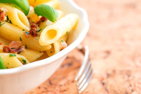 Penne pasta with pesto , sun-dried tomatoes, sweet chilly and pine nutsの写真素材