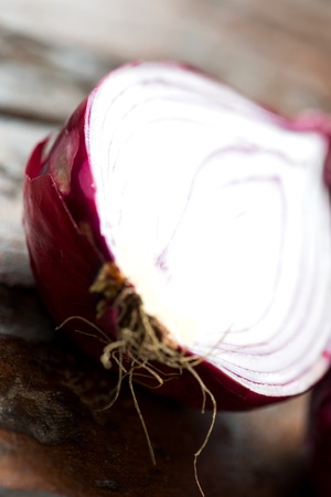 Fresh red onion close up on an old wooden tableの写真素材